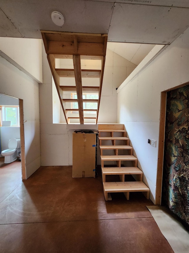 stairway featuring concrete flooring
