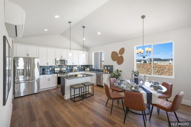 5741 S Sherri Lea Rd, Spokane, WA 99224 - kitchen featuring appliances with stainless steel finishes, a chandelier, a center island, white cabinetry, and backsplash