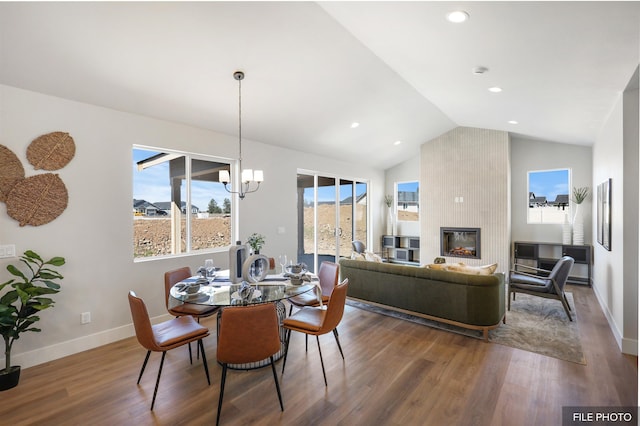 5741 S Sherri Lea Rd, Spokane, WA 99224 - dining space with vaulted ceiling, wood finished floors, a chandelier, baseboards, and a tiled fireplace