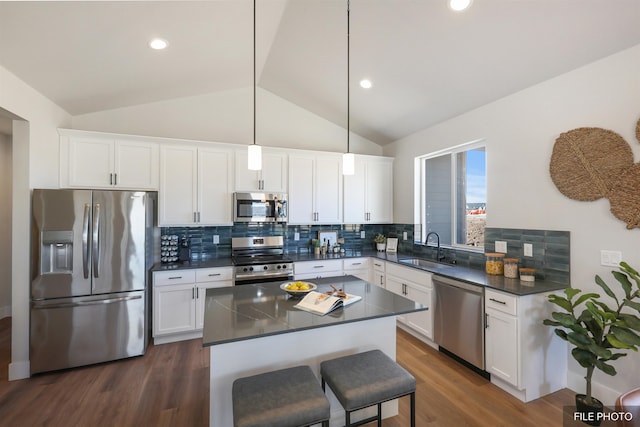 5741 S Sherri Lea Rd, Spokane, WA 99224 - kitchen featuring appliances with stainless steel finishes, a sink, dark countertops, lofted ceiling, and dark wood finished floors