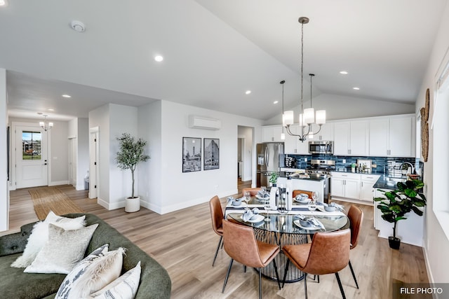 5741 S Sherri Lea Rd, Spokane, WA 99224 - dining space featuring a chandelier, a wall unit AC, vaulted ceiling, light wood-style flooring, and recessed lighting
