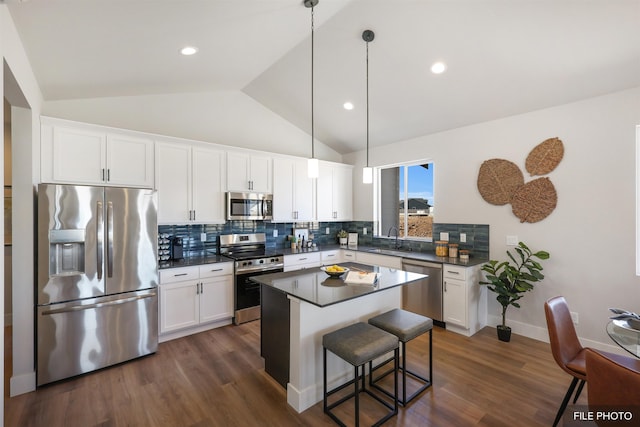 5741 S Sherri Lea Rd, Spokane, WA 99224 - kitchen featuring stainless steel appliances, a sink, dark countertops, vaulted ceiling, and decorative backsplash
