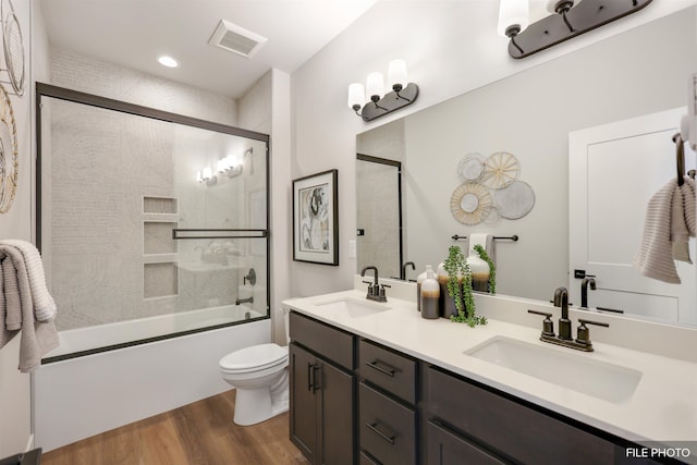 5741 S Sherri Lea Rd, Spokane, WA 99224 - full bath with wood finished floors, toilet, combined bath / shower with glass door, double vanity, and recessed lighting