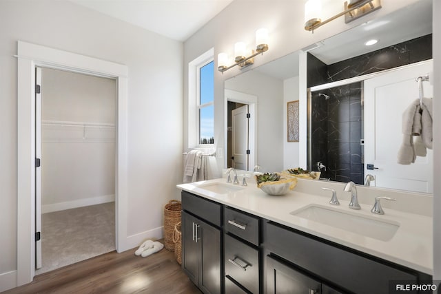 5741 S Sherri Lea Rd, Spokane, WA 99224 - full bath with wood finished floors, a stall shower, a spacious closet, double vanity, and baseboards