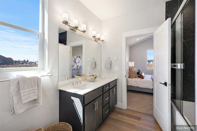 5741 S Sherri Lea Rd, Spokane, WA 99224 - ensuite bathroom with wood finished floors, a shower with shower door, plenty of natural light, and double vanity