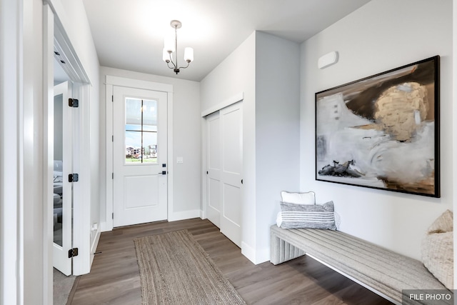 5741 S Sherri Lea Rd, Spokane, WA 99224 - doorway to outside featuring wood finished floors, baseboards, and a chandelier