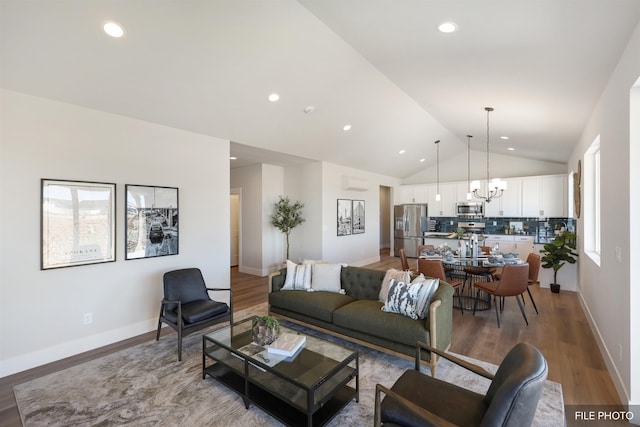 5741 S Sherri Lea Rd, Spokane, WA 99224 - living room featuring a chandelier, vaulted ceiling, light wood-style floors, recessed lighting, and baseboards