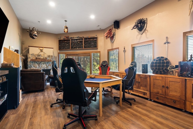 playroom with recessed lighting, an office area, wood finished floors, and a fireplace