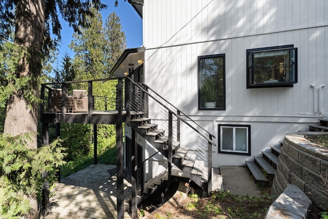 view of home's exterior with stairway and a wooden deck