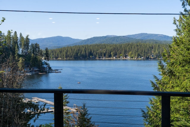 water view featuring a forest and a mountain backdrop