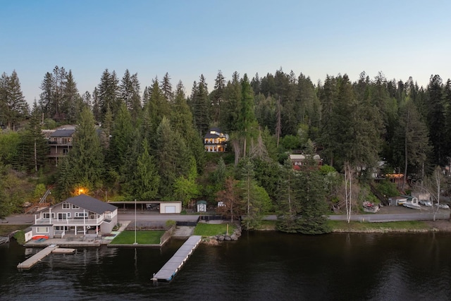 dock area featuring a water view and a wooded view