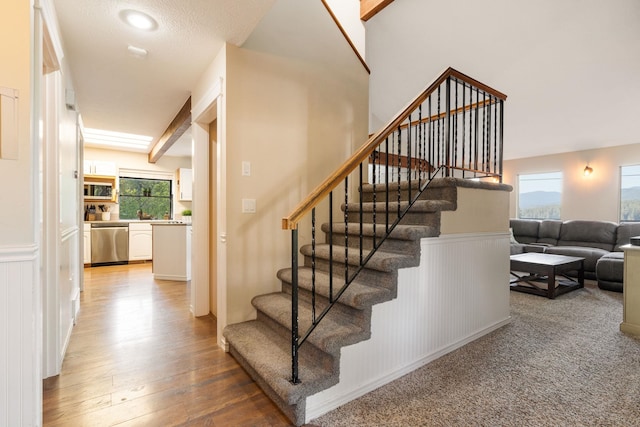staircase with wood finished floors