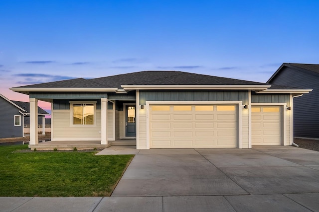 5763 S Sherri Lea Rd, Spokane, WA 99224 - view of front of property with a garage, concrete driveway, covered porch, and a front lawn