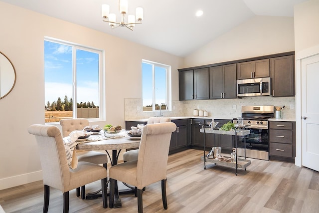 5763 S Sherri Lea Rd, Spokane, WA 99224 - dining room with a chandelier, light wood-style flooring, healthy amount of natural light, high vaulted ceiling, and recessed lighting