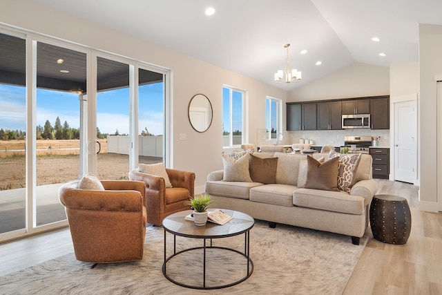 5763 S Sherri Lea Rd, Spokane, WA 99224 - living room with light wood-type flooring, a chandelier, recessed lighting, and high vaulted ceiling