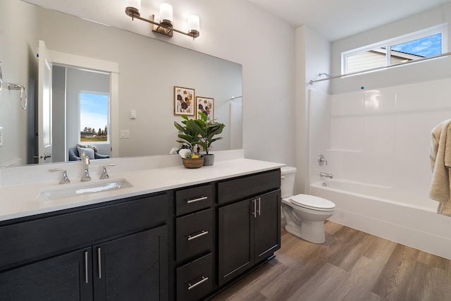5763 S Sherri Lea Rd, Spokane, WA 99224 - bathroom with wood finished floors, toilet, vanity, and bathtub / shower combination