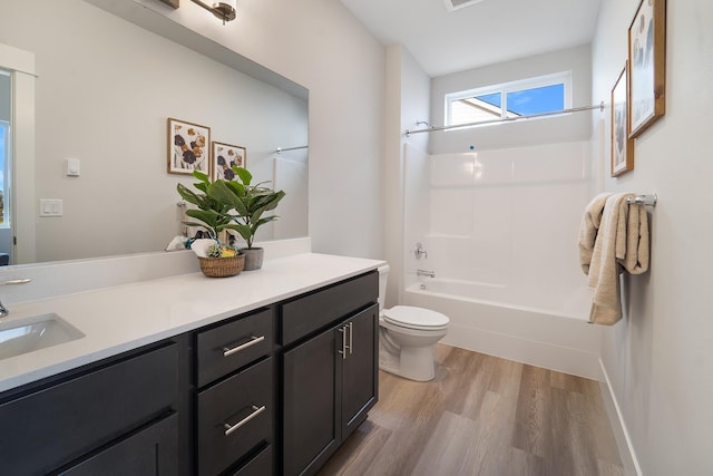 5763 S Sherri Lea Rd, Spokane, WA 99224 - bathroom with wood finished floors, toilet, washtub / shower combination, and vanity