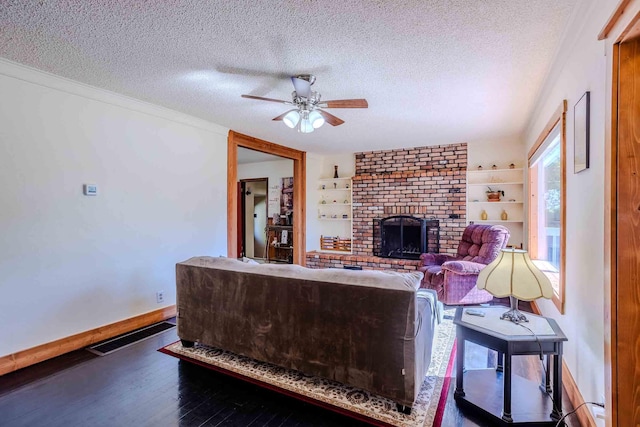 211 4th St, Dover, ID 83825 - living area featuring a textured ceiling, ceiling fan, a brick fireplace, wood finished floors, and baseboards