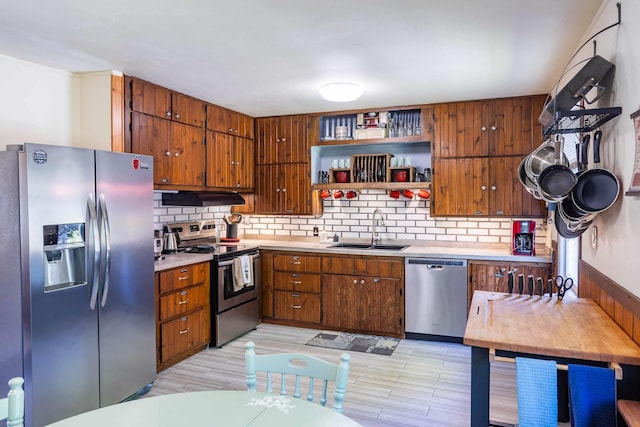 211 4th St, Dover, ID 83825 - kitchen featuring stainless steel appliances, a sink, under cabinet range hood, and light countertops