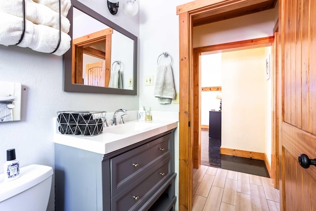 211 4th St, Dover, ID 83825 - bathroom featuring vanity, toilet, and wood finished floors
