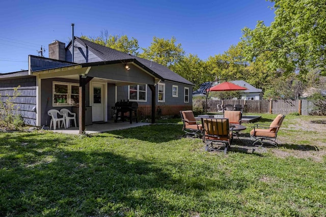 211 4th St, Dover, ID 83825 - back of property featuring a chimney and a patio area