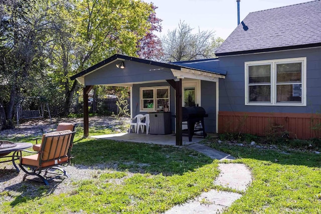 211 4th St, Dover, ID 83825 - back of house featuring a patio area and a shingled roof