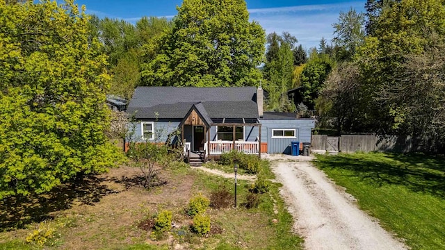 211 4th St, Dover, ID 83825 - view of front of property with driveway, a chimney, and covered porch
