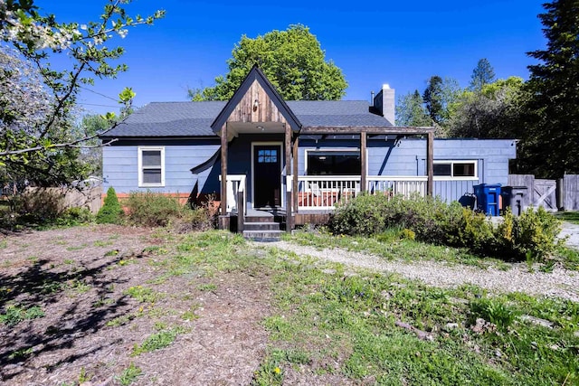 211 4th St, Dover, ID 83825 - view of front of house featuring a chimney and a porch