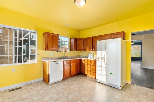 217 S Broadway St, Tekoa, WA 99033 - kitchen with white appliances, light countertops, baseboards, and plenty of natural light