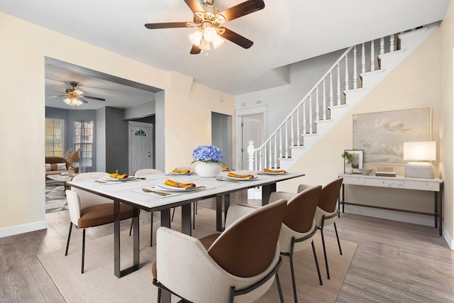 217 S Broadway St, Tekoa, WA 99033 - dining room featuring a ceiling fan, stairway, wood finished floors, and baseboards