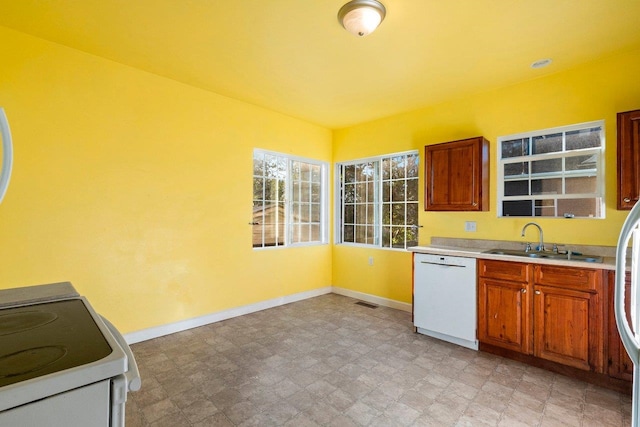 217 S Broadway St, Tekoa, WA 99033 - kitchen with white appliances, a sink, baseboards, and light countertops