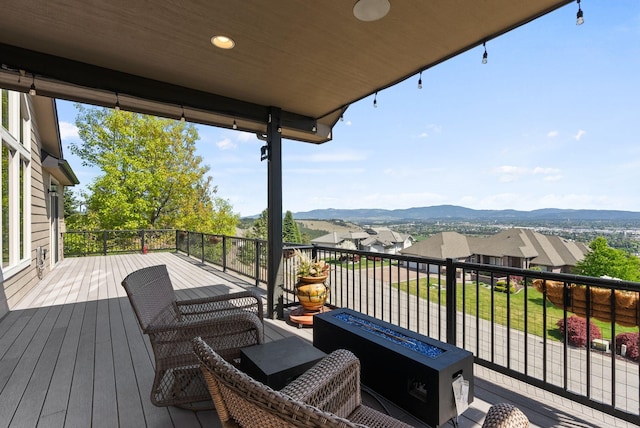 8504 E Black Oak Ln, Spokane, WA 99217 - wooden terrace featuring a fire pit, a mountain view, and a residential view