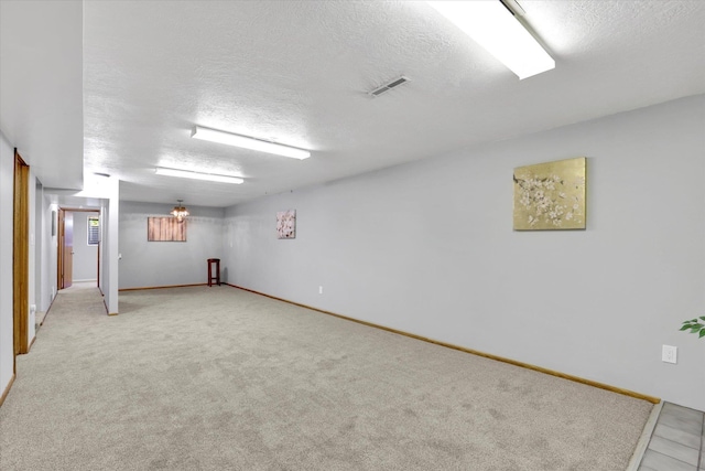 13519 E 26th Ave, Spokane, WA 99216 - finished below grade area with a textured ceiling, light colored carpet, and baseboards
