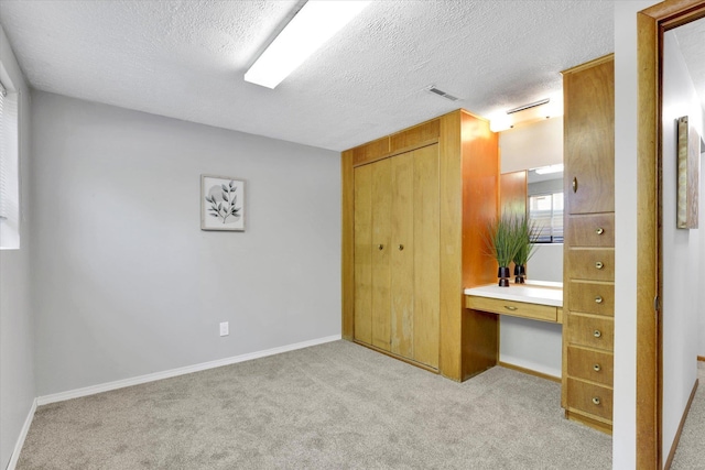 13519 E 26th Ave, Spokane, WA 99216 - unfurnished bedroom featuring carpet, a textured ceiling, a desk, and baseboards