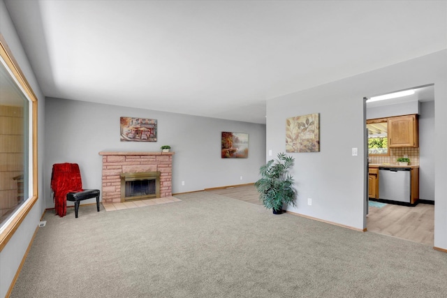 13519 E 26th Ave, Spokane, WA 99216 - living room with light colored carpet, a fireplace, and baseboards