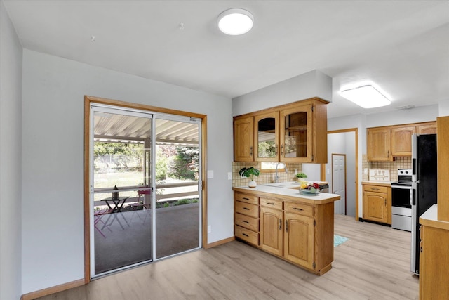 13519 E 26th Ave, Spokane, WA 99216 - kitchen with light countertops, stainless steel electric range, light wood-style flooring, and backsplash
