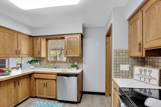 13519 E 26th Ave, Spokane, WA 99216 - kitchen featuring stainless steel dishwasher, a sink, light wood-type flooring, and light countertops