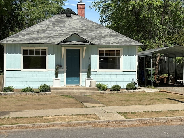 1711 E 14th Ave, Spokane, WA 99202 - bungalow-style house featuring a shingled roof, a chimney, and a detached carport