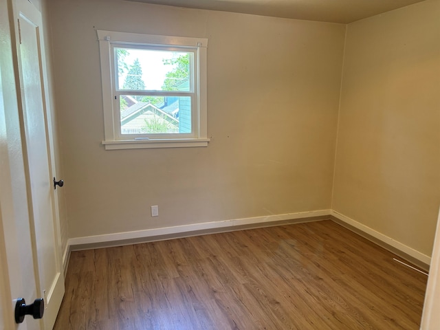 1711 E 14th Ave, Spokane, WA 99202 - empty room with wood finished floors and baseboards