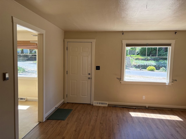 1711 E 14th Ave, Spokane, WA 99202 - entryway featuring wood finished floors, healthy amount of natural light, and baseboards