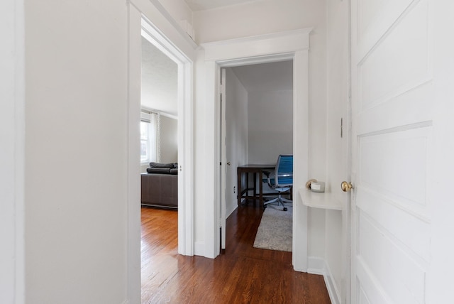 hall featuring dark wood-type flooring and a desk