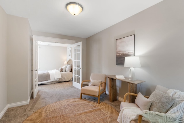living area with carpet floors, baseboards, and french doors