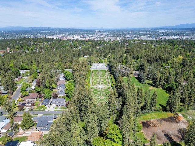 aerial view of property and surrounding area featuring a mountainous background