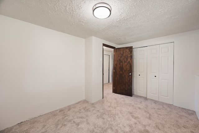3326 E Pineglen Ave, Mead, WA 99021 - unfurnished bedroom with carpet, a textured ceiling, and a closet