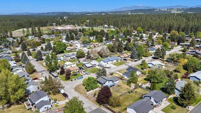 3326 E Pineglen Ave, Mead, WA 99021 - aerial view of property's location featuring a heavily wooded area, nearby suburban area, and mountains
