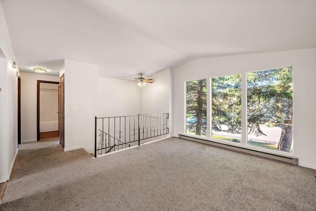 3326 E Pineglen Ave, Mead, WA 99021 - carpeted empty room with baseboard heating, a ceiling fan, lofted ceiling, baseboards, and a textured ceiling