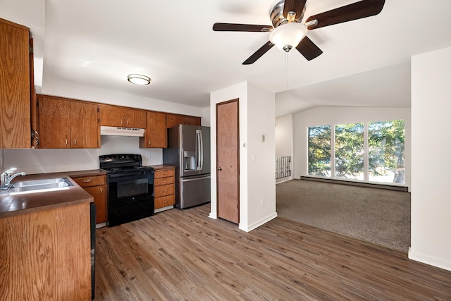 3326 E Pineglen Ave, Mead, WA 99021 - kitchen featuring black electric range, a sink, under cabinet range hood, stainless steel fridge, and brown cabinetry