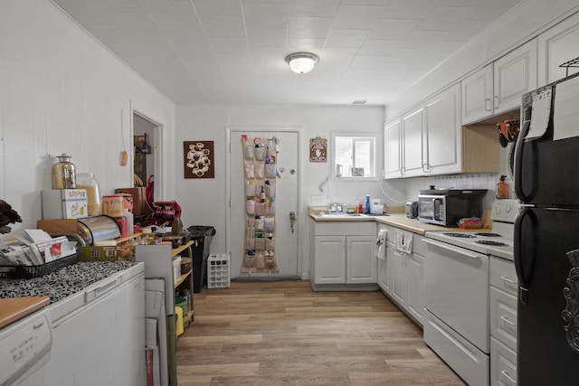 420 E Sanson Ave, Spokane, WA 99207 - kitchen featuring white range with electric cooktop, freestanding refrigerator, stainless steel microwave, light wood finished floors, and light countertops