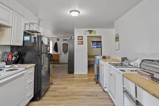 420 E Sanson Ave, Spokane, WA 99207 - kitchen with white electric range oven, light wood-style flooring, white cabinetry, and butcher block counters