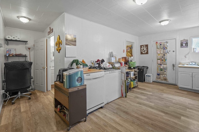 420 E Sanson Ave, Spokane, WA 99207 - kitchen with light wood-style flooring, a desk, white dishwasher, a sink, and light countertops